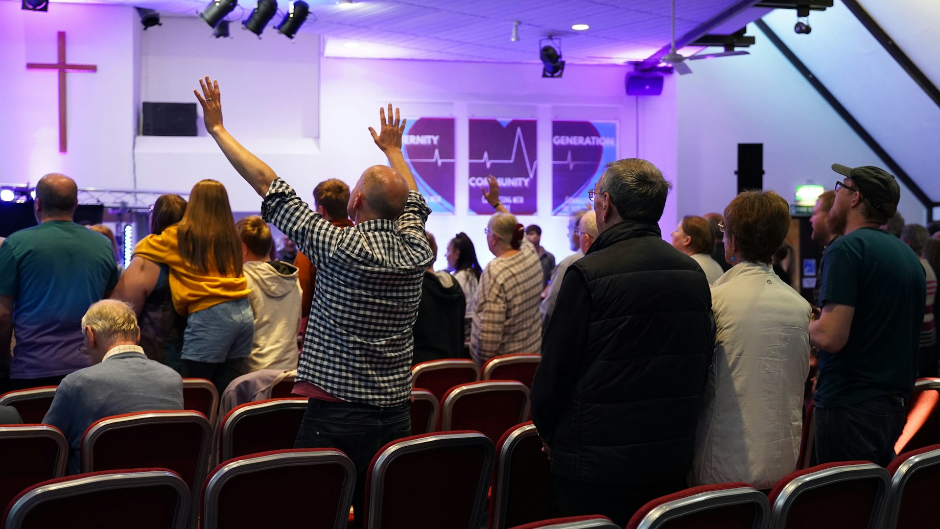 Church congregation facing worship screens