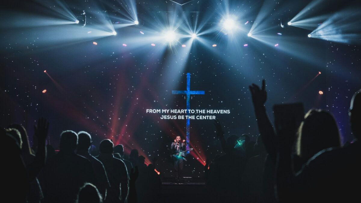 Worship lyrics displayed on a large church screen