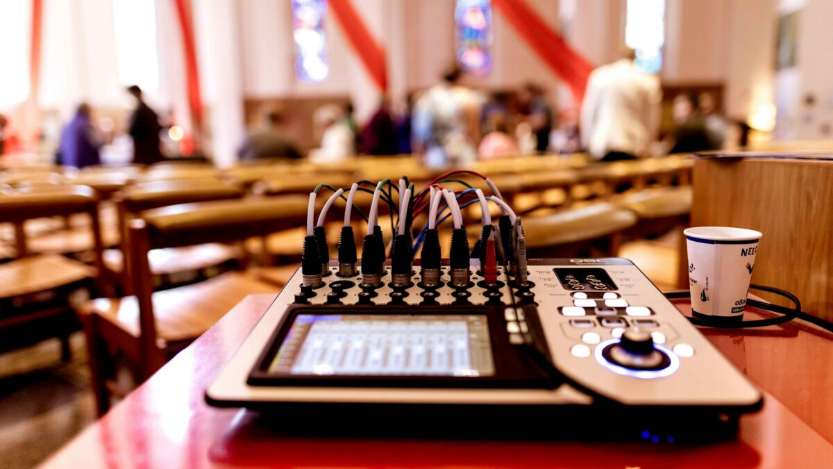 Audio mixing console in church sanctuary during soundcheck