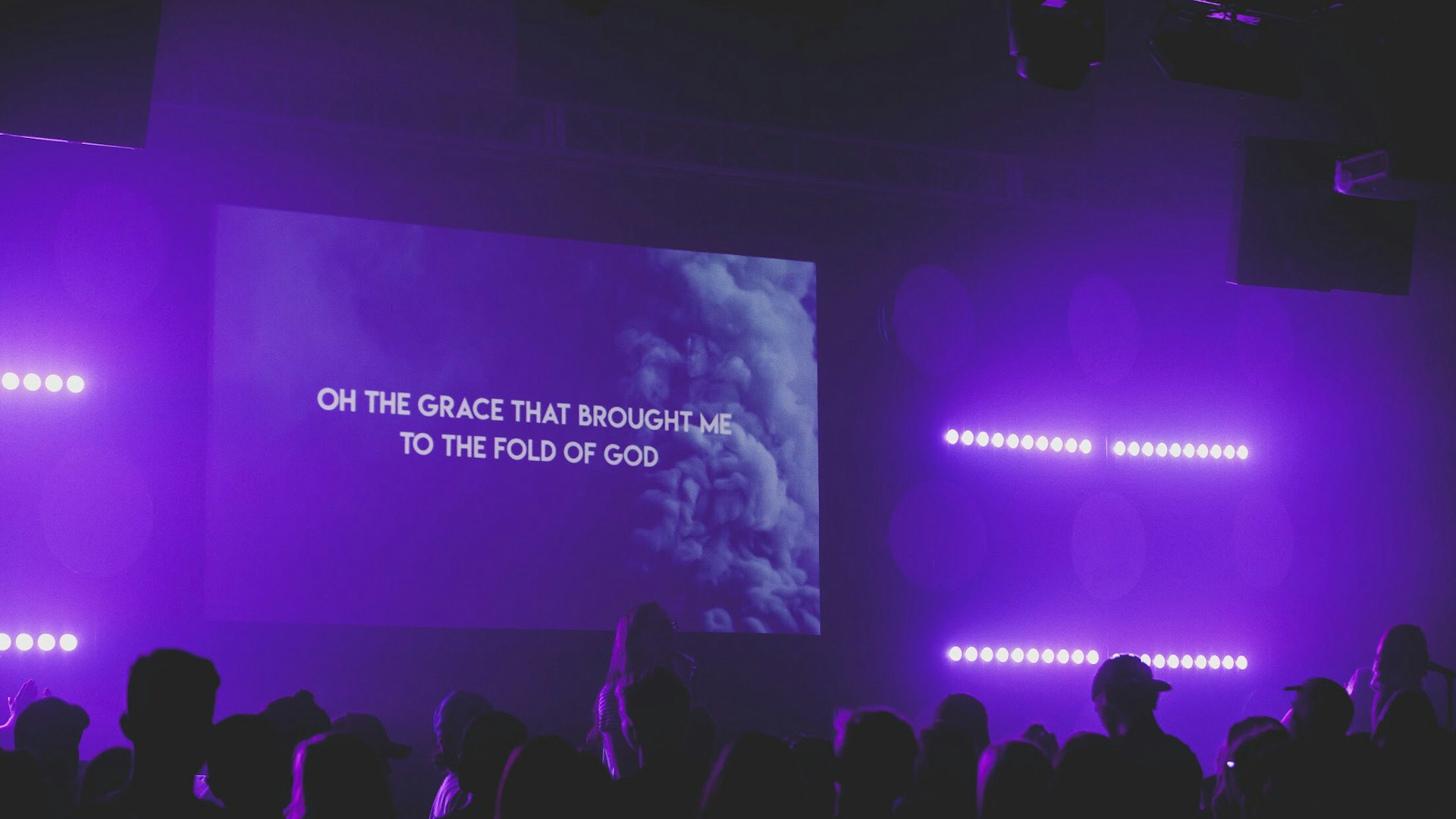 Large screen displaying a projected message in a worship space