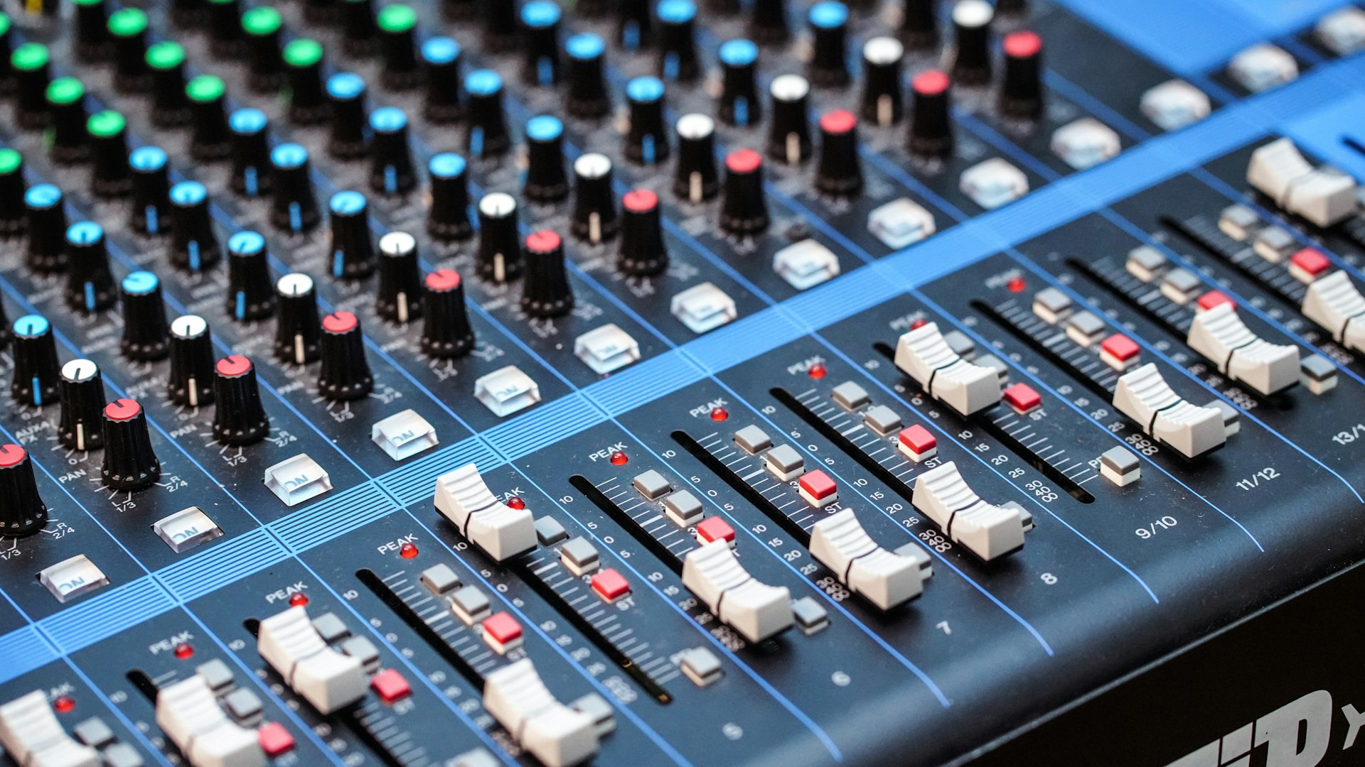 Close-up of audio mixing console faders in a church sound system