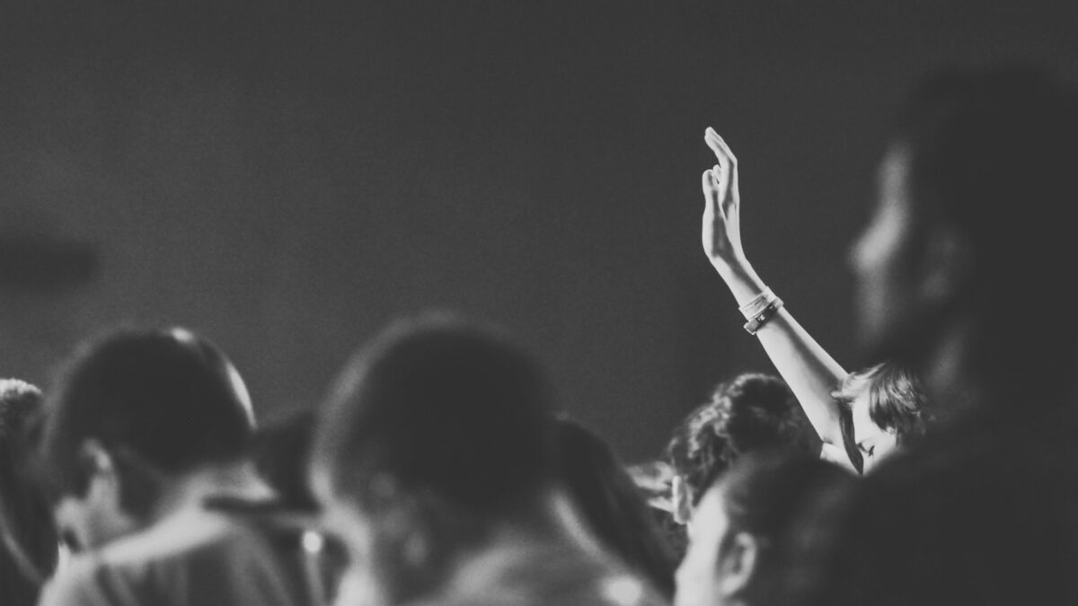 Church congregation worshipping with hands raised