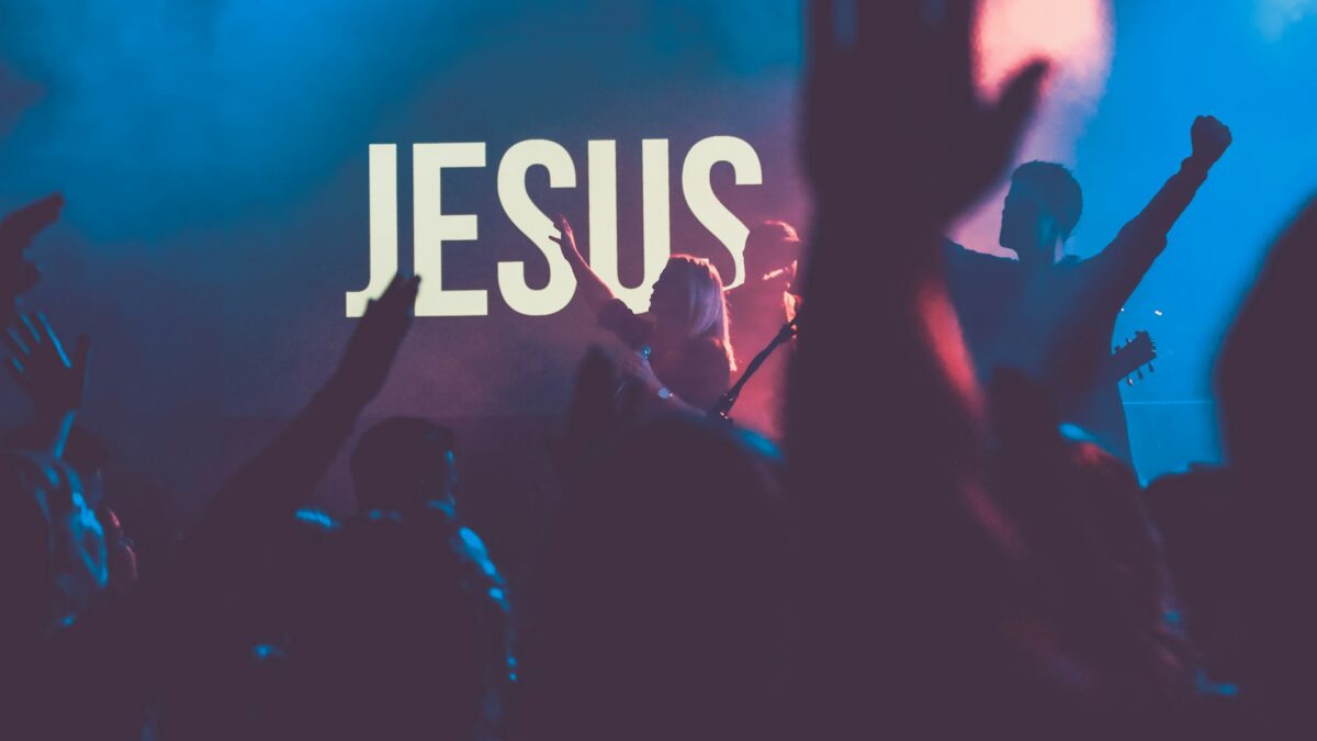 Worship band performing on a church stage with lights